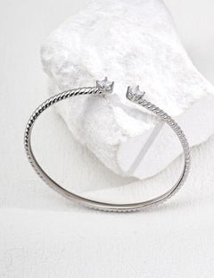 Silver bracelet with star-shaped clasps on a white background