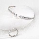 silver bracelets on a light gray background