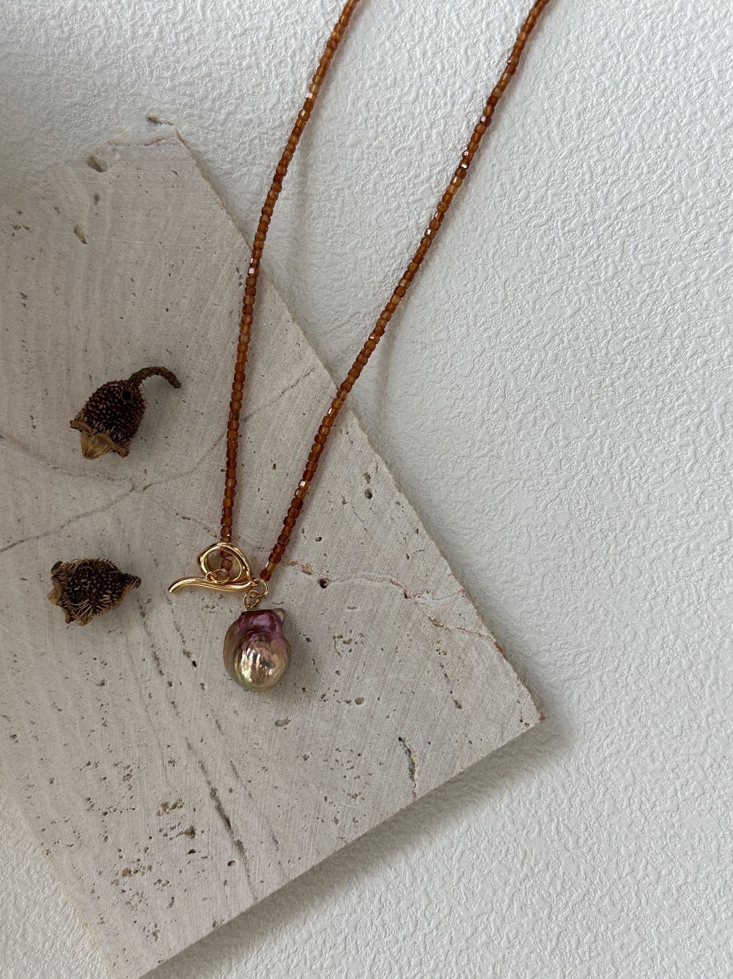 Necklace with a pendant on a textured surface
