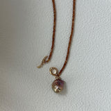 Necklace with a pendant on a plain background