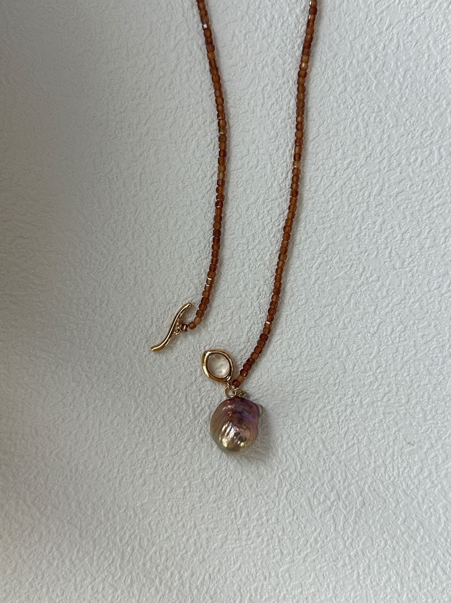 Necklace with a pendant on a plain background