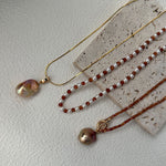 Three necklaces with beads on a textured surface