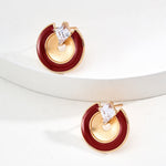 Gold and red earrings with clear gemstones on a white background