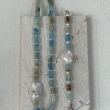 Necklace with blue and silver beads on a white background