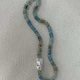 Necklace with blue and silver beads on a white background