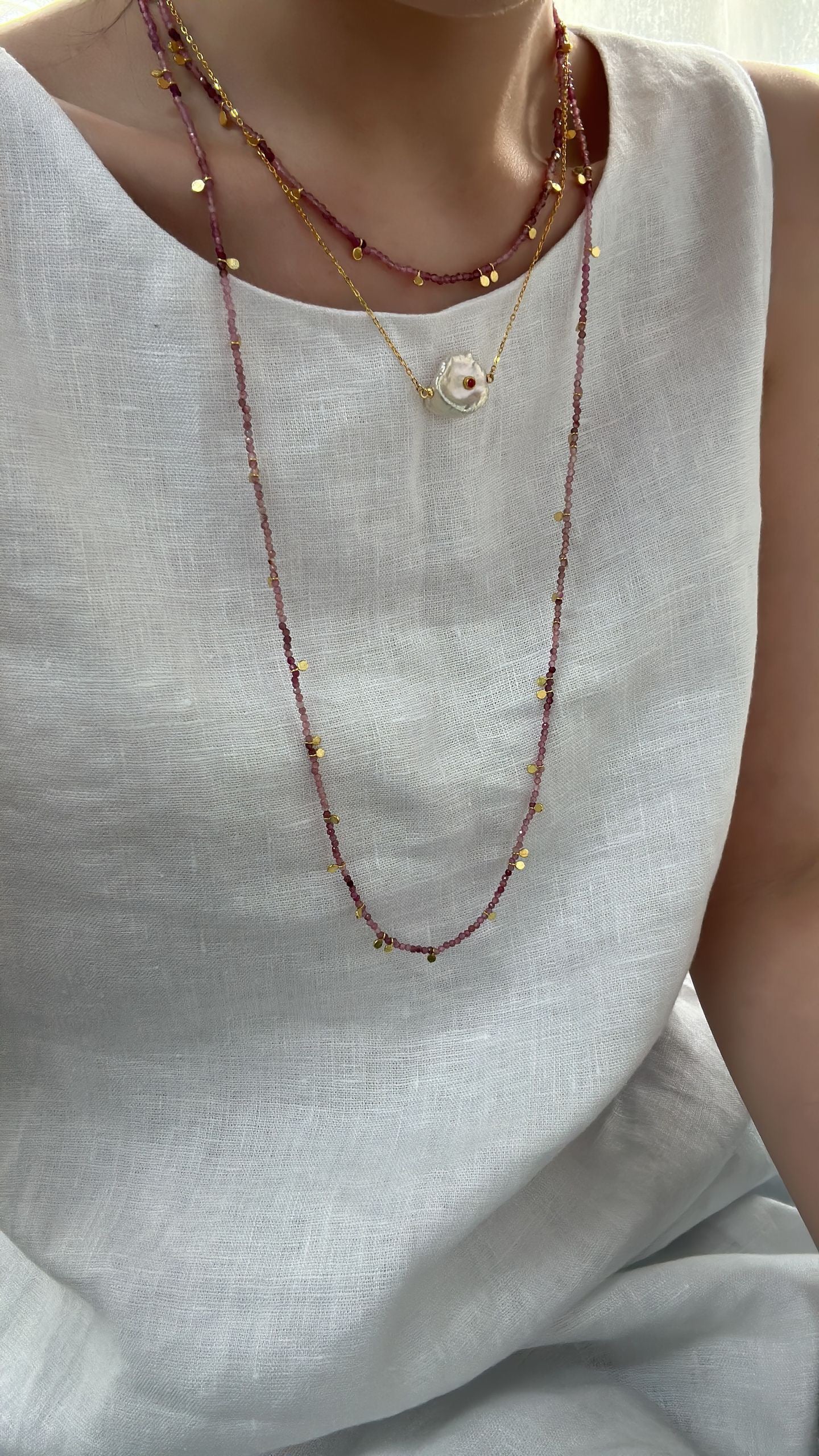 Necklace with small beads on a plain background