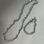 Pearl necklace on a light gray background