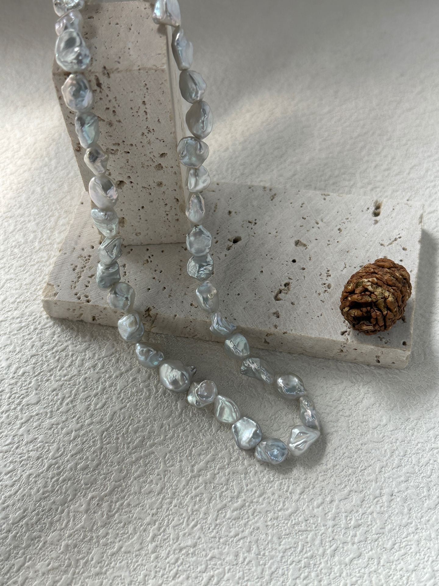 Necklace with clear beads on a textured surface
