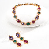 Jewelry set with multicolored gemstones on a white background