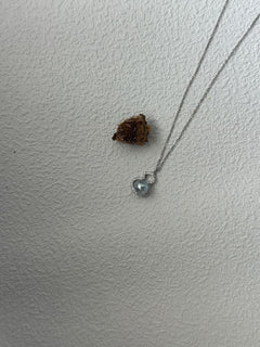 Heart-shaped pendant necklace on a plain white background