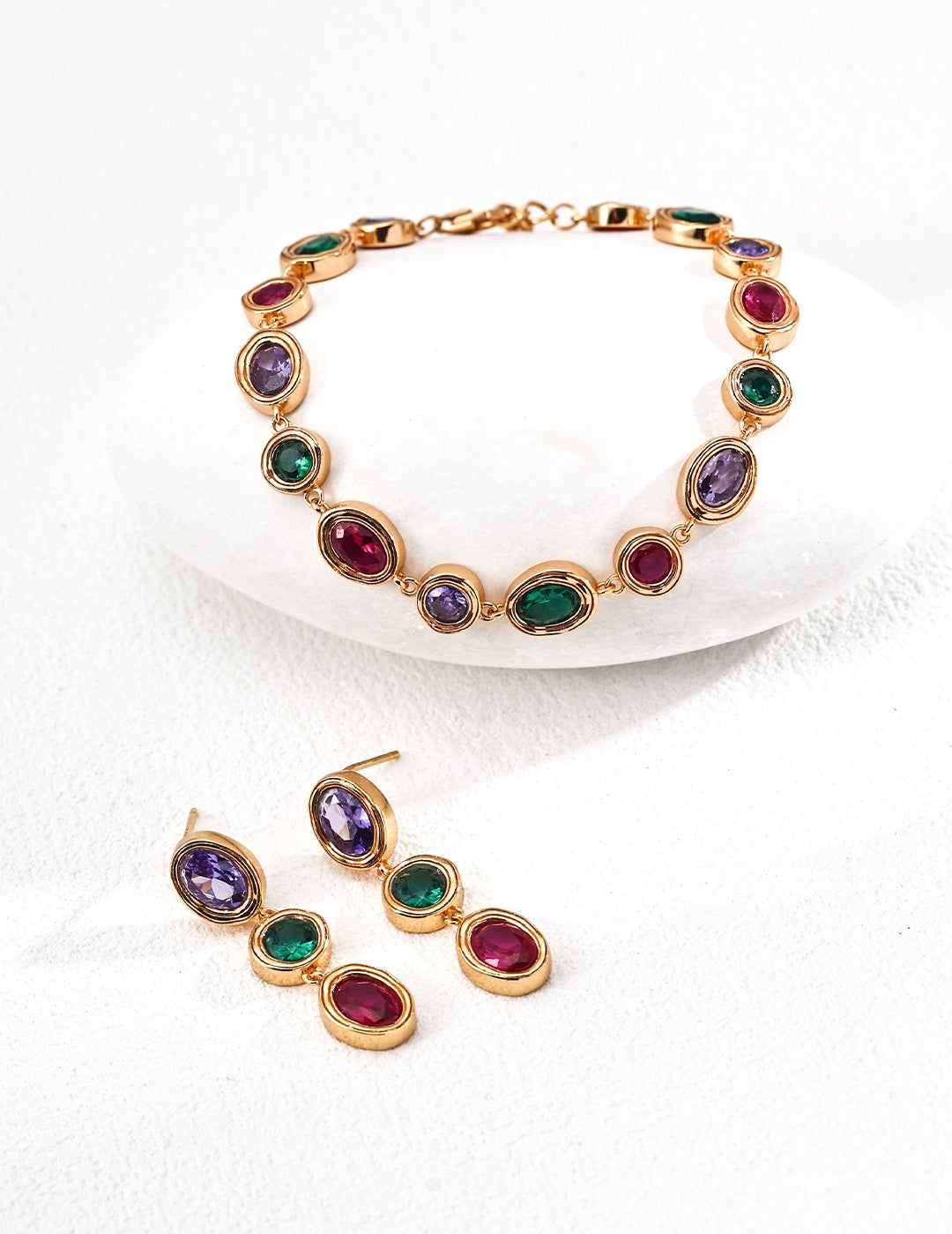 Jewelry set with multicolored gemstones on a white background