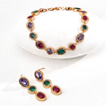 Jewelry set with multicolored gemstones on a white background