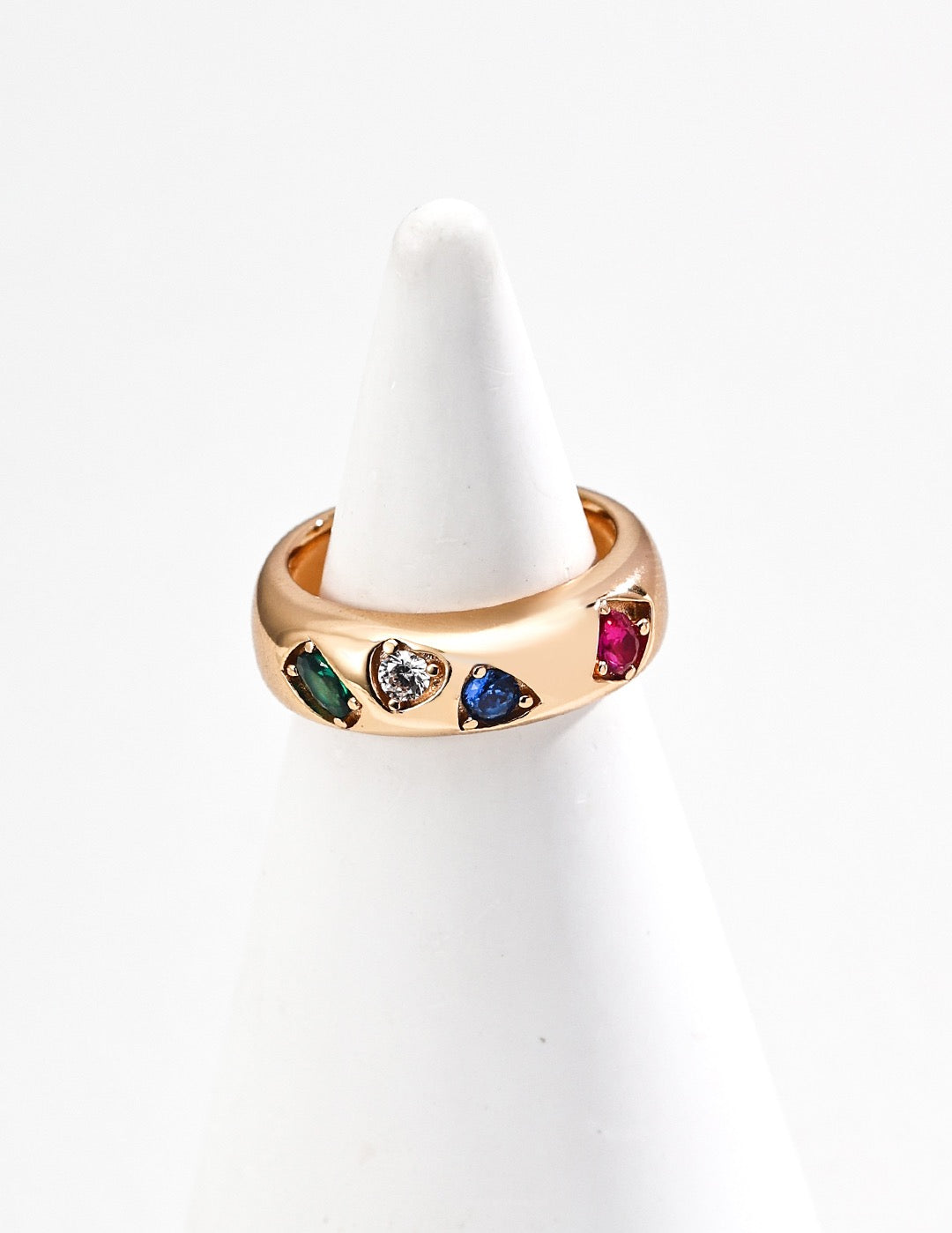 Gold ring with colorful gemstones on a white background