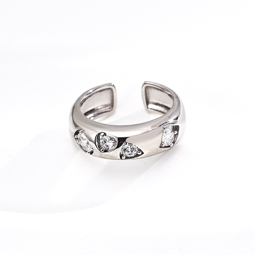 Silver ring with embedded stones on a white background