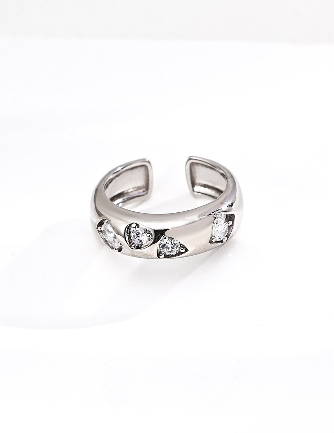Silver ring with embedded stones on a white background