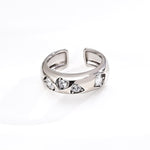 Silver ring with embedded stones on a white background