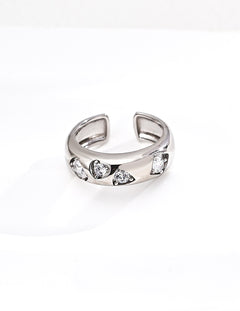 Silver ring with embedded stones on a white background