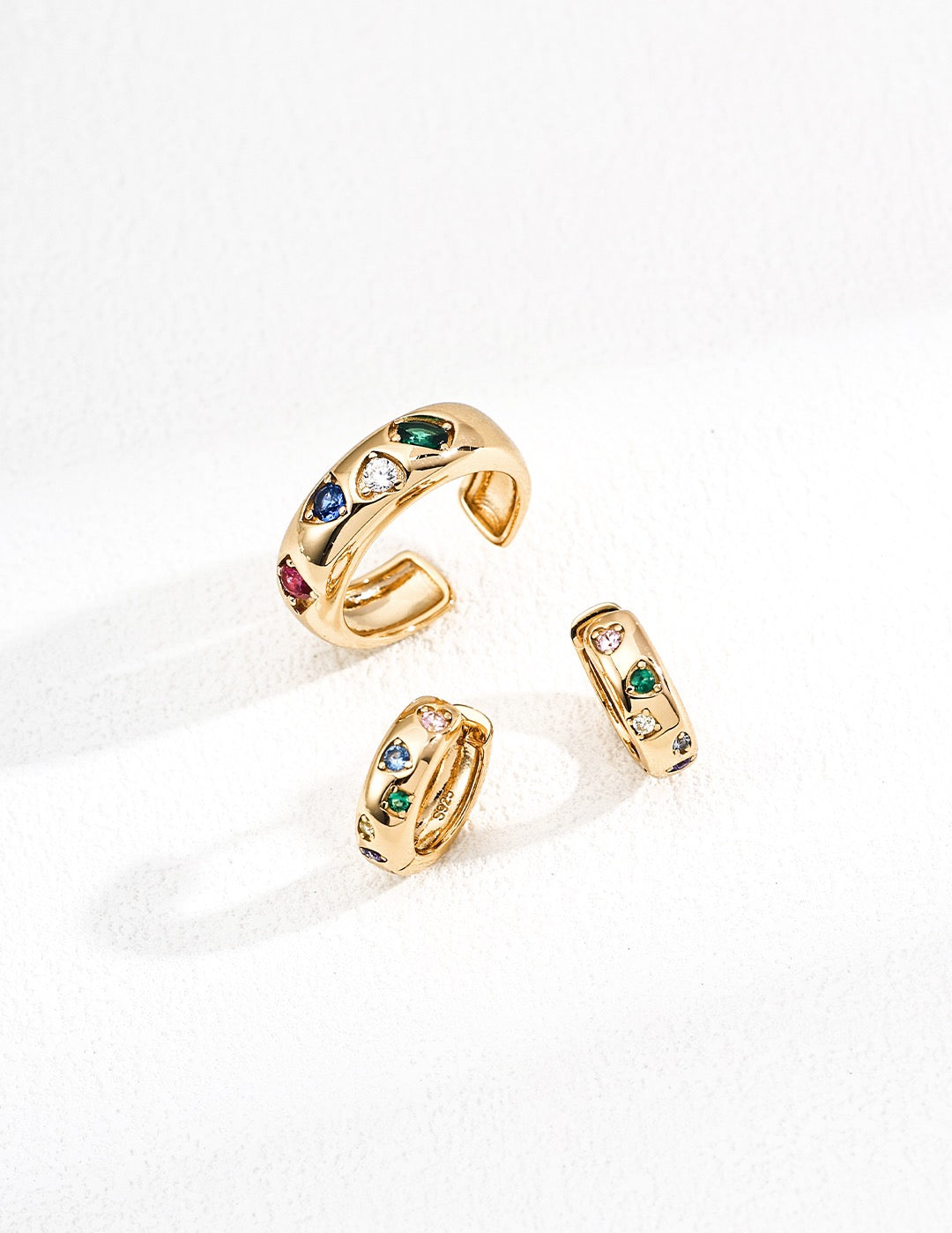 Set of gold rings with gemstones on a white background