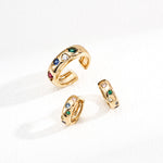 Set of gold rings with gemstones on a white background