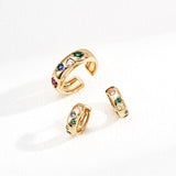 Set of gold rings with gemstones on a white background