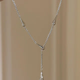 Silver necklace with a pendant on a beige background, featuring the brand 'CEISUR'.