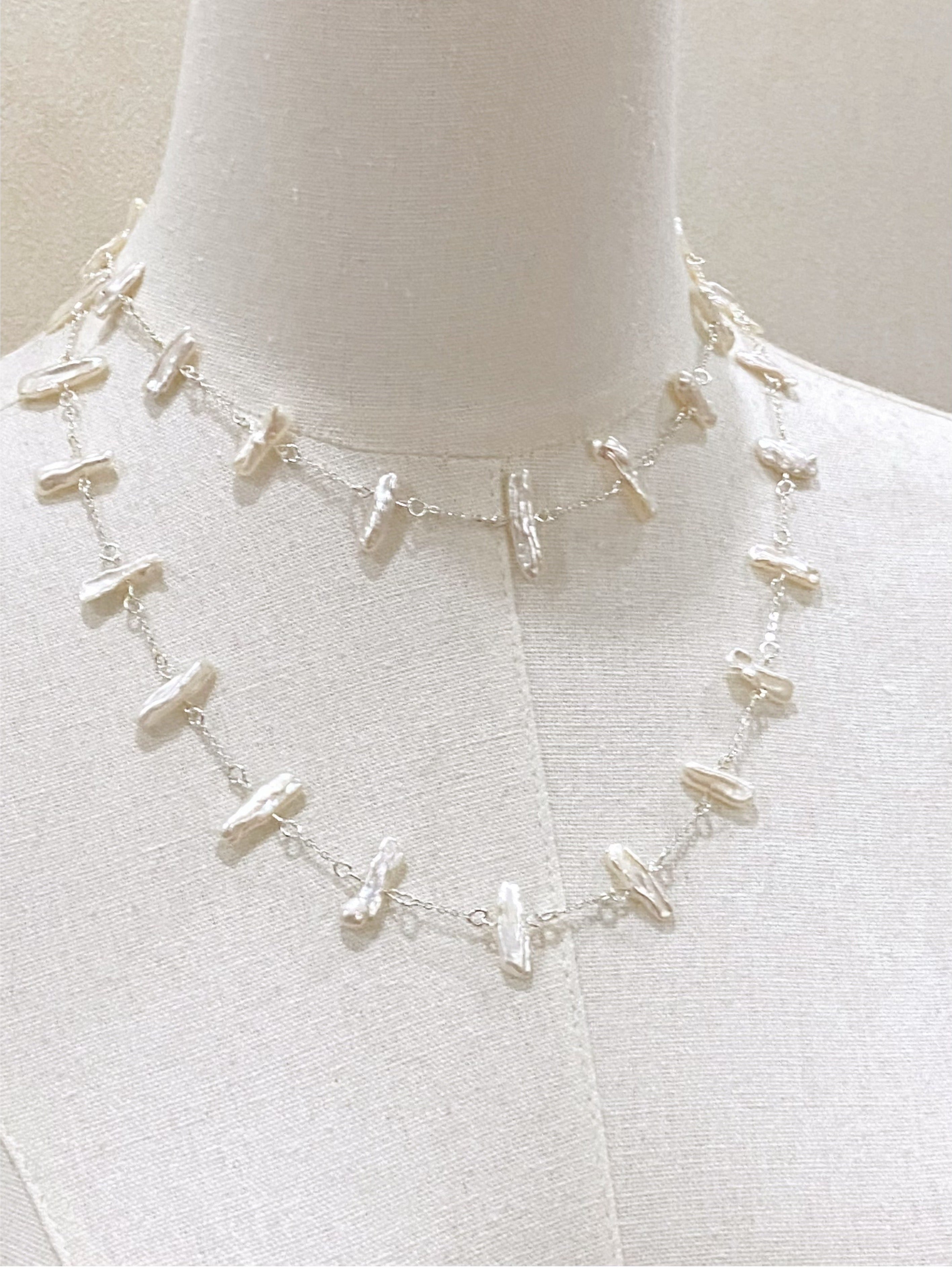 Necklace on a mannequin with a plain background