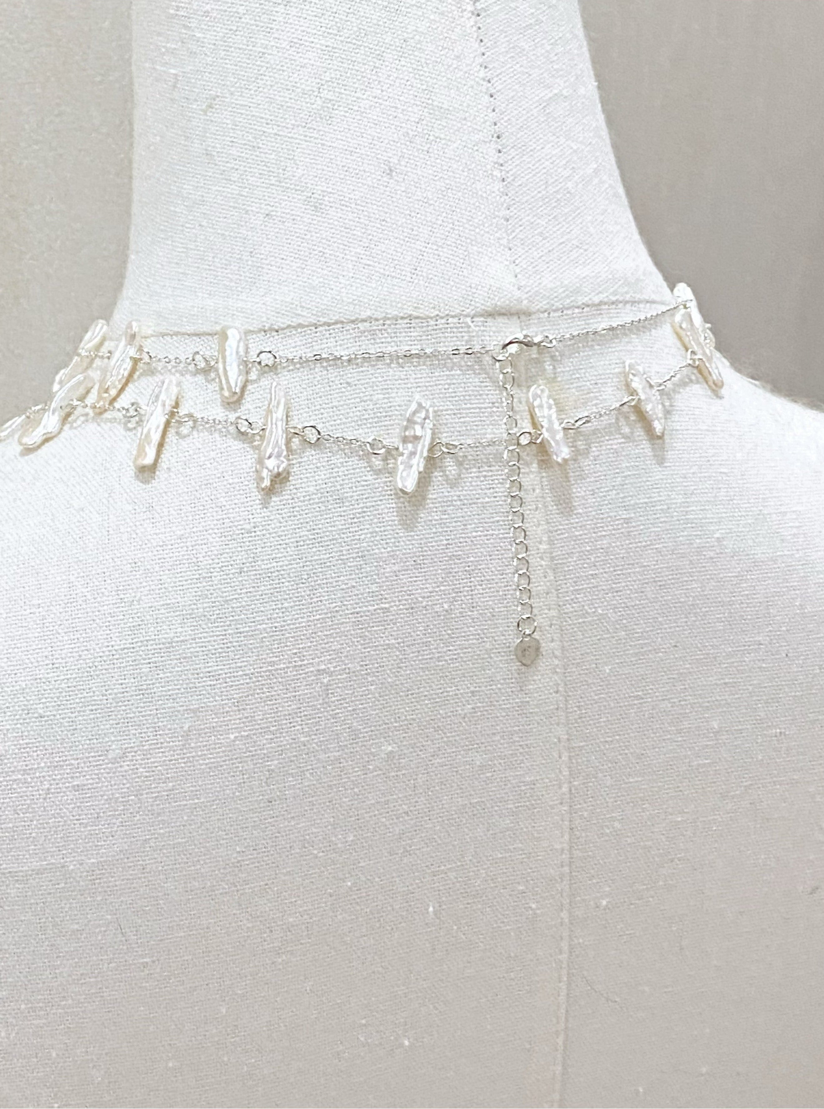 Silver chain belt on a mannequin with a plain background