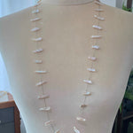 Necklace with keshi pearl on a mannequin against a neutral background